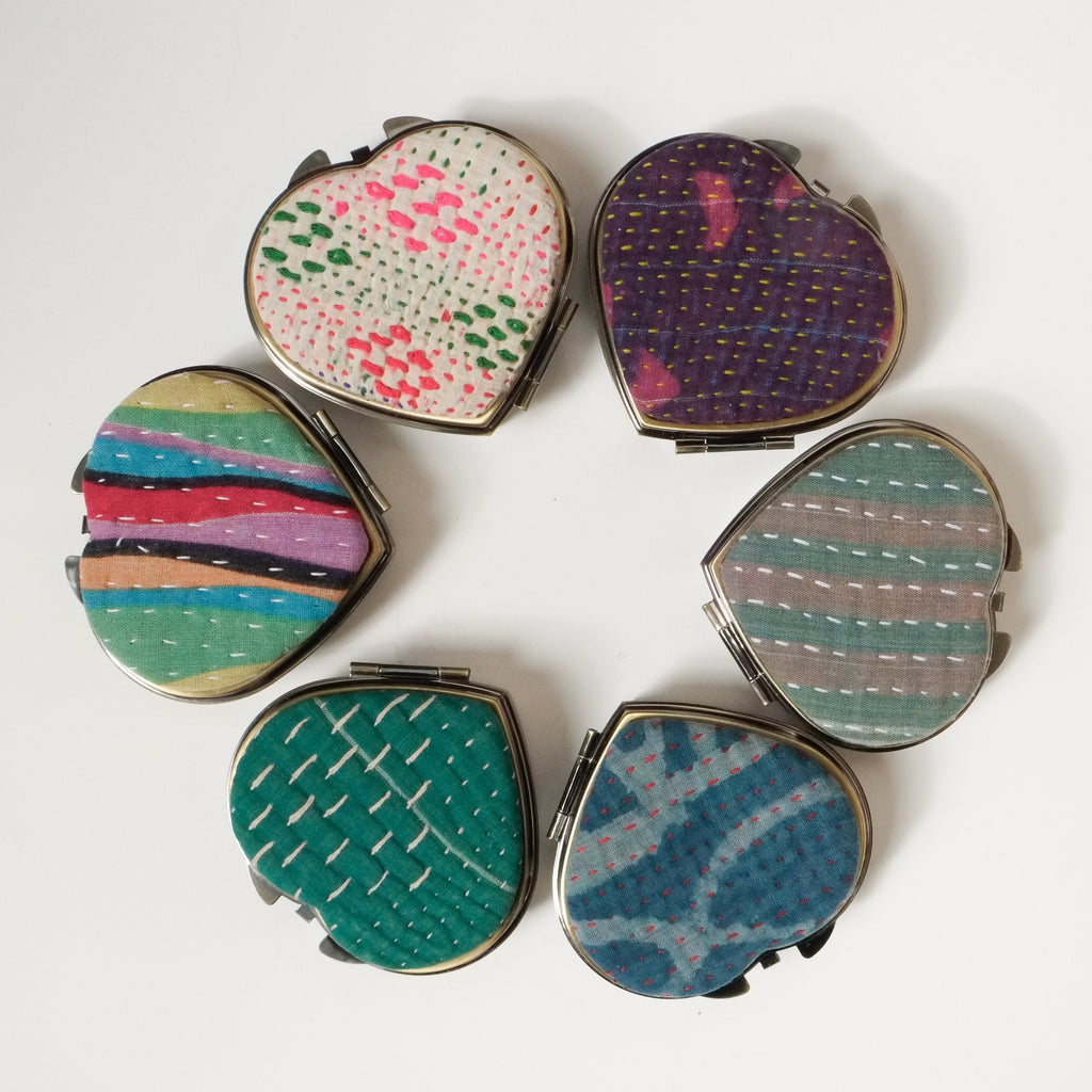 6 heart shaped compacts arranged in a circle